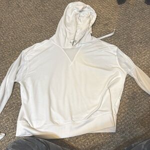 This is a large white dkny sweater. It has mesh sleeves and a mesh neckline